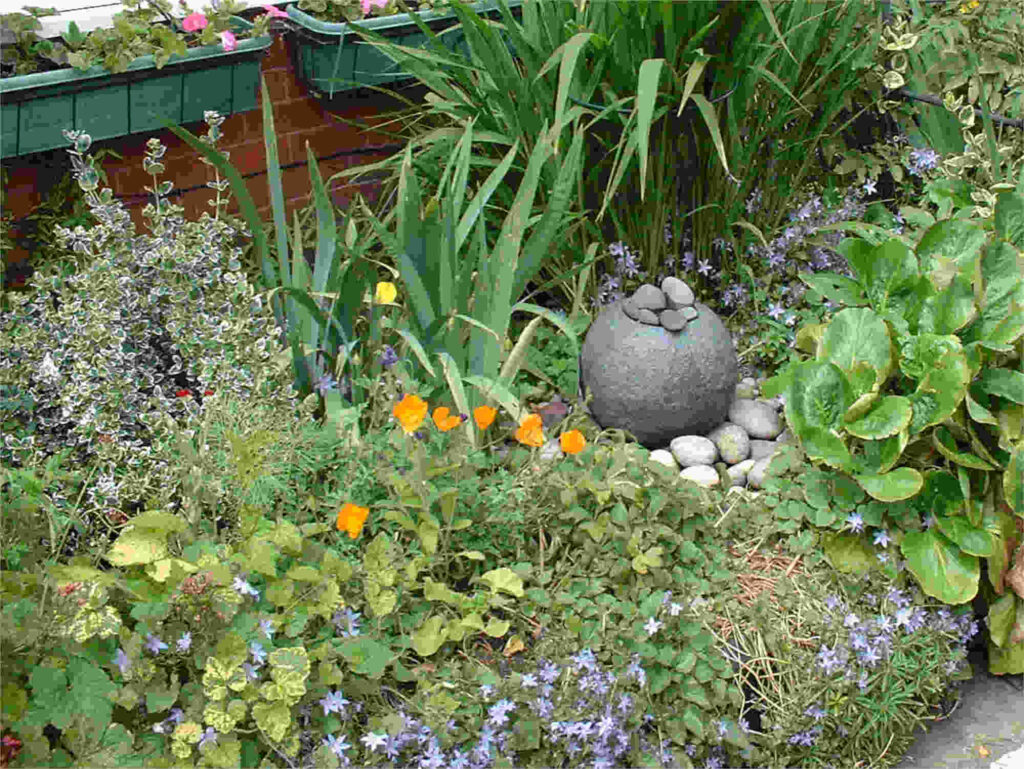 small set of pretty stones surrounded by plants in a border